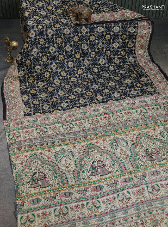 Printed silk saree black and cream with allover ikat prints and madhubani printed pallu & border