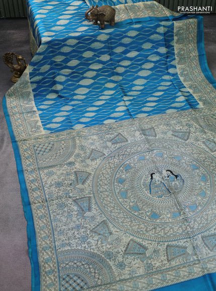 Printed silk saree cs blue and cream with allover shibori prints and madhubani printed pallu & border