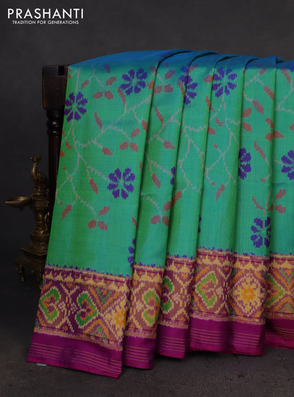 Rajkot patola silk saree dual shade of teal green and purple with allover ikat weaves and ikat woven zari border