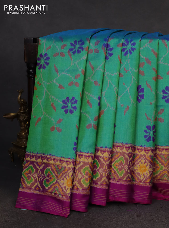 Rajkot patola silk saree dual shade of teal green and purple with allover ikat weaves and ikat woven zari border