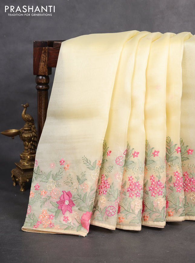 Pure organza silk saree pale yellow with plain body and floral embroidery border