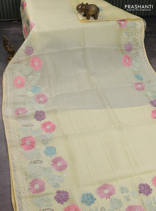 Pure organza silk saree pale yellow with plain body and long floral embroidery border