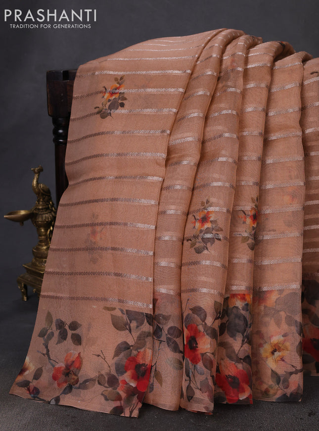 Pure organza silk saree rust shade with allover zari strip & floral digital prints and floral digital printed border