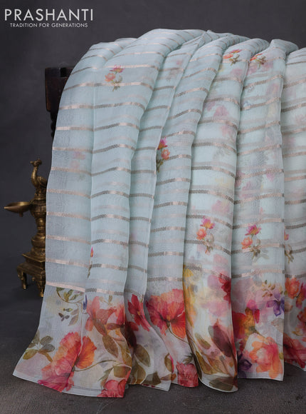 Pure organza silk saree light blue with allover zari strip & floral digital prints and floral digital printed border