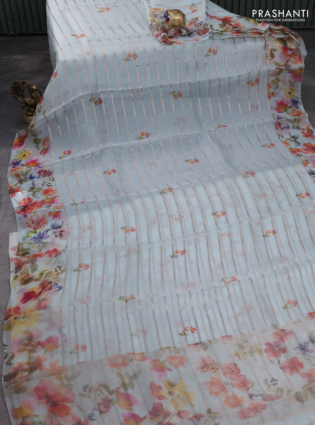 Pure organza silk saree light blue with allover zari strip & floral digital prints and floral digital printed border