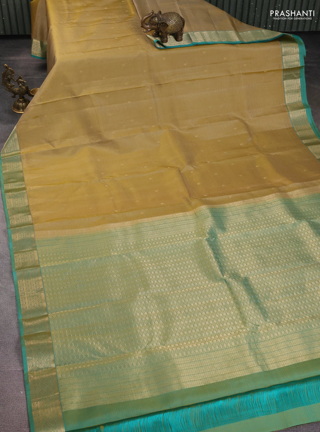Pure kanchipuram silk saree beige and dual shade of teal with zari woven buttas and temple design zari woven border