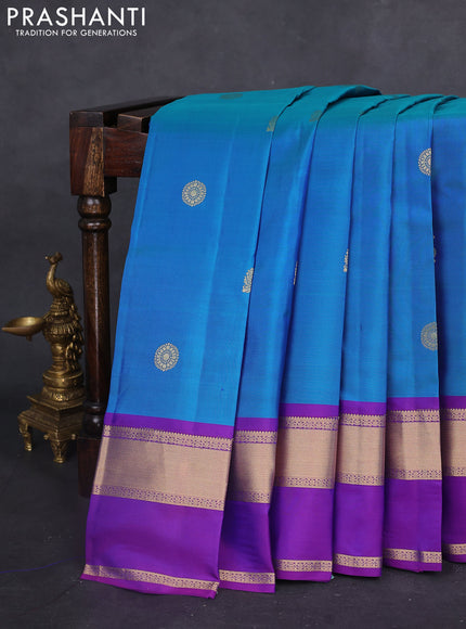 Pure kanchipuram silk saree dual shade of bluish green and purple with zari woven buttas and long rettapet zari woven border
