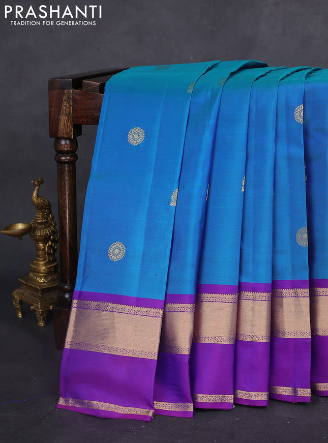 Pure kanchipuram silk saree dual shade of bluish green and purple with zari woven buttas and long rettapet zari woven border