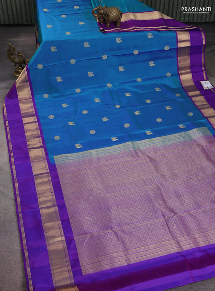 Pure kanchipuram silk saree dual shade of bluish green and purple with zari woven buttas and long rettapet zari woven border