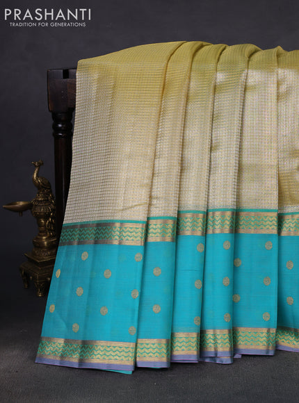Kora kanchipuram silk saree pale yellow and teal blue with allover zari stripes pattern and zari woven butta border