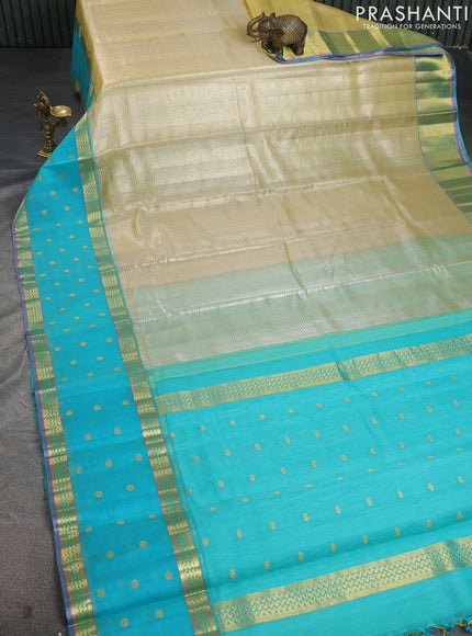 Kora kanchipuram silk saree pale yellow and teal blue with allover zari stripes pattern and zari woven butta border