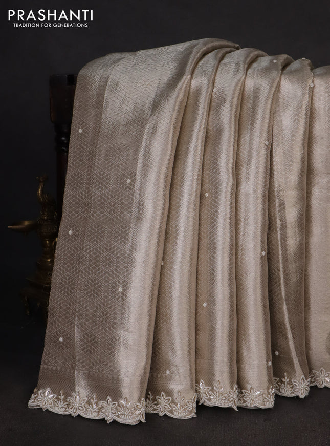 Pure tissue silk saree off white with allover zari woven brocade weaves & beaded work and beaded work border