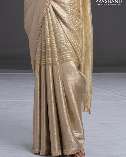 Pure tissue silk saree beige with Half & half style zari weaves and beaded work border