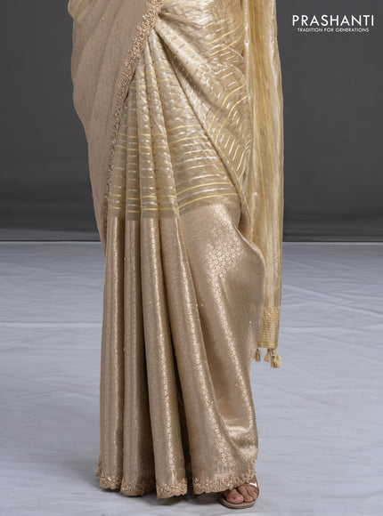 Pure tissue silk saree beige with Half & half style zari weaves and beaded work border