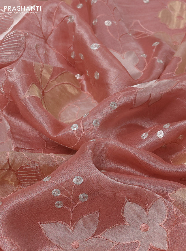 Pure tissue silk saree peach shade with allover floral embroidery work and simple embroidery border