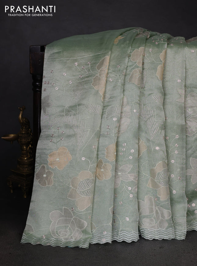Pure tissue silk saree pastel green with allover floral embroidery work and simple embroidery border