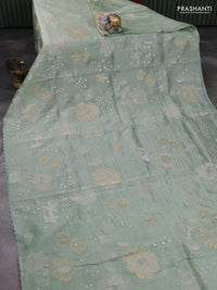 Pure tissue silk saree pastel green with allover floral embroidery work and simple embroidery border