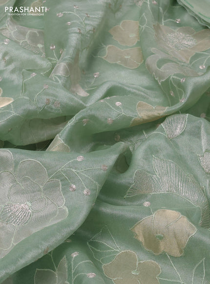 Pure tissue silk saree pastel green with allover floral embroidery work and simple embroidery border
