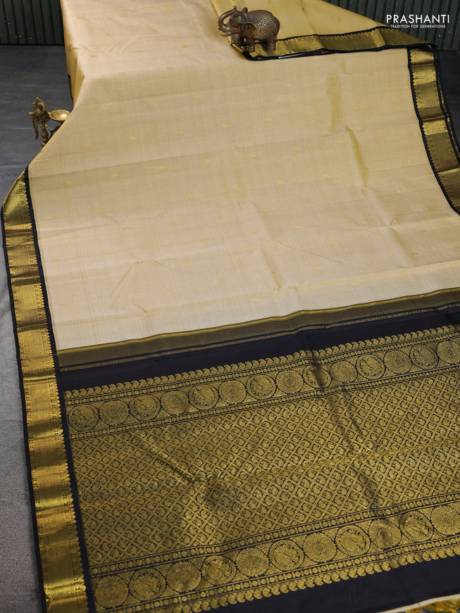 Pure kanchipuram silk saree cream and black with zari woven buttas and zari woven korvai border