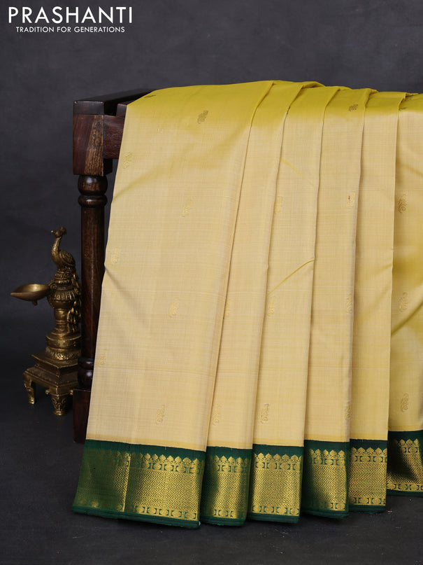 Pure kanchipuram silk saree pale yellow and green with allover zari woven buttas and zari woven korvai border