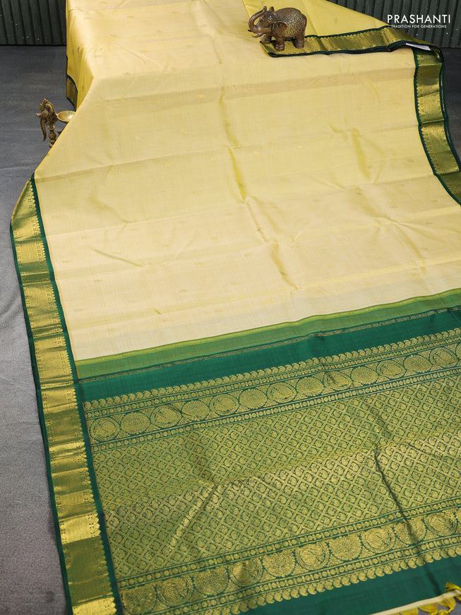 Pure kanchipuram silk saree pale yellow and green with allover zari woven buttas and zari woven korvai border