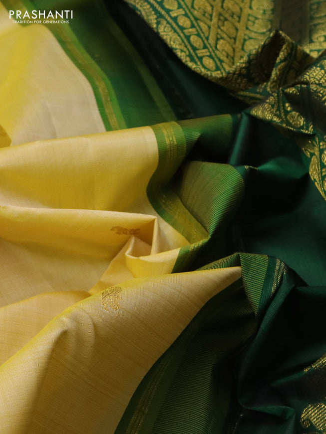 Pure kanchipuram silk saree pale yellow and green with allover zari woven buttas and zari woven korvai border