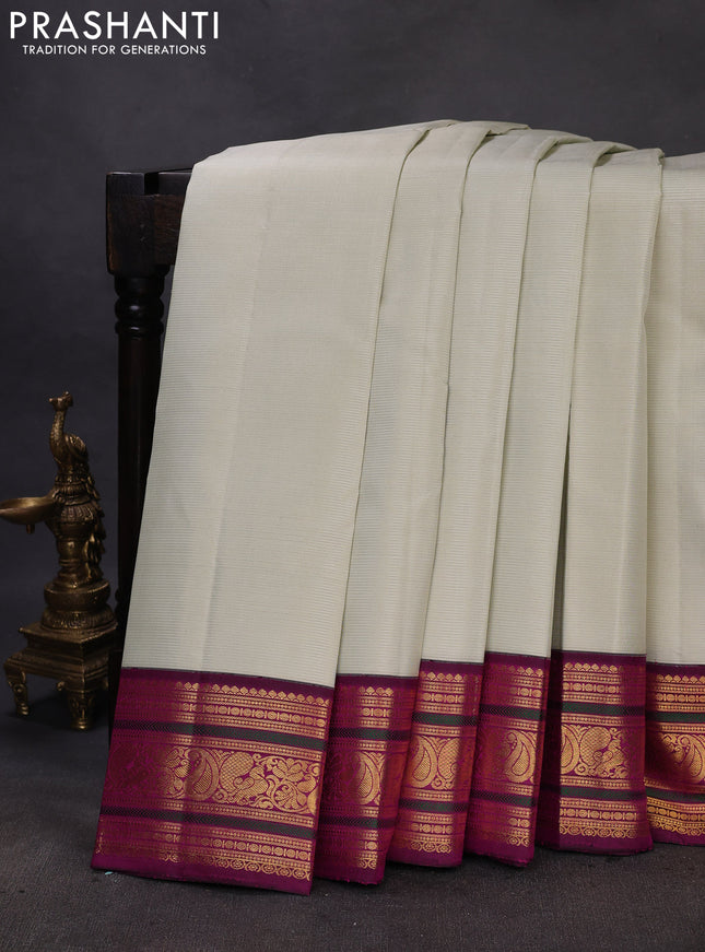 Pure kanchipuram silk saree mild pista green and purple with allover zari woven stripe pattern and zari woven korvai border