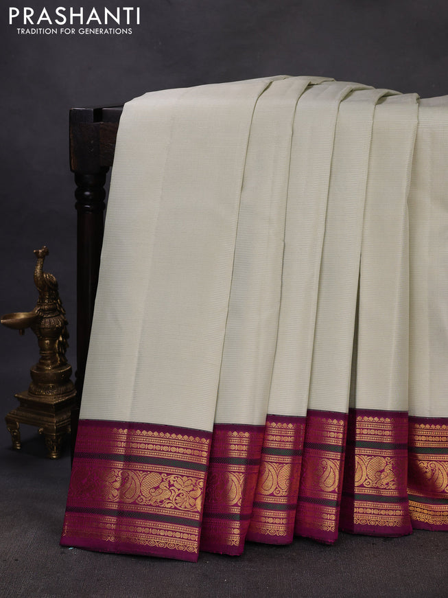Pure kanchipuram silk saree mild pista green and purple with allover zari woven stripe pattern and zari woven korvai border