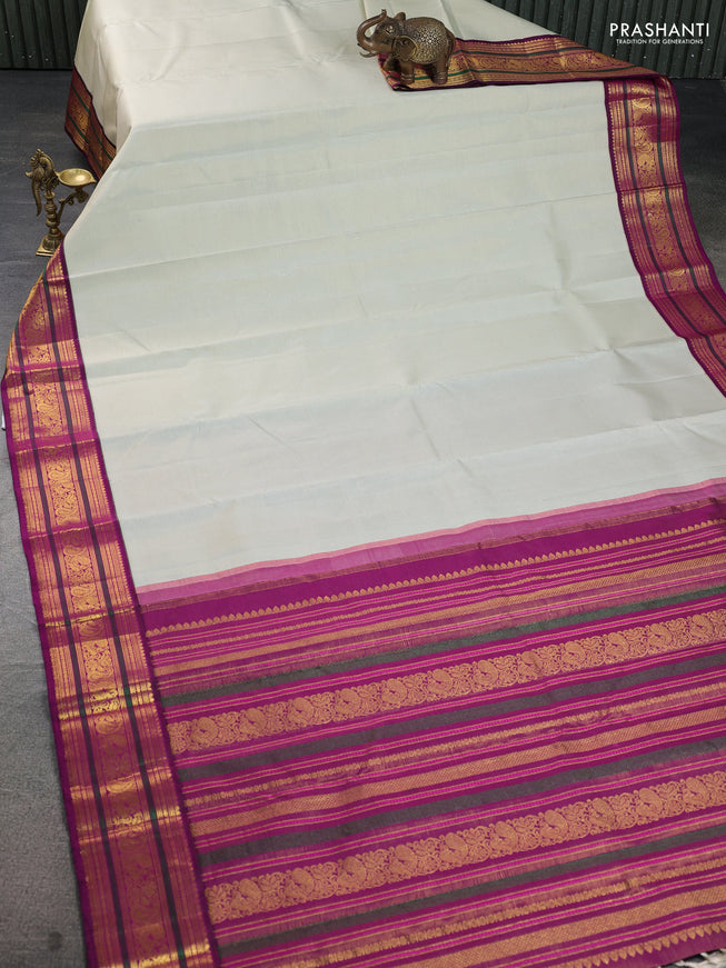 Pure kanchipuram silk saree mild pista green and purple with allover zari woven stripe pattern and zari woven korvai border