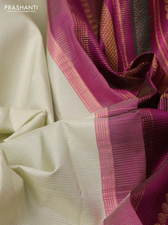 Pure kanchipuram silk saree mild pista green and purple with allover zari woven stripe pattern and zari woven korvai border