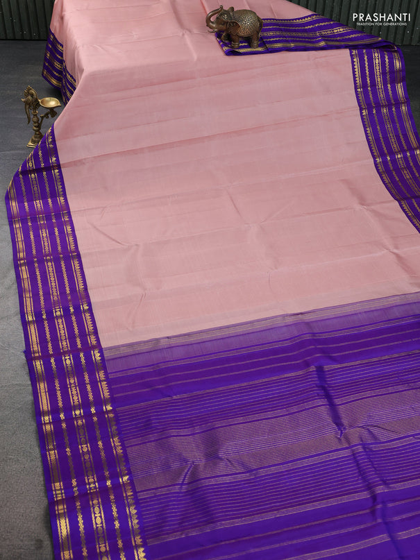 Pure kanchipuram silk saree pastel peach and violet with plain body and rich zari woven korvai border