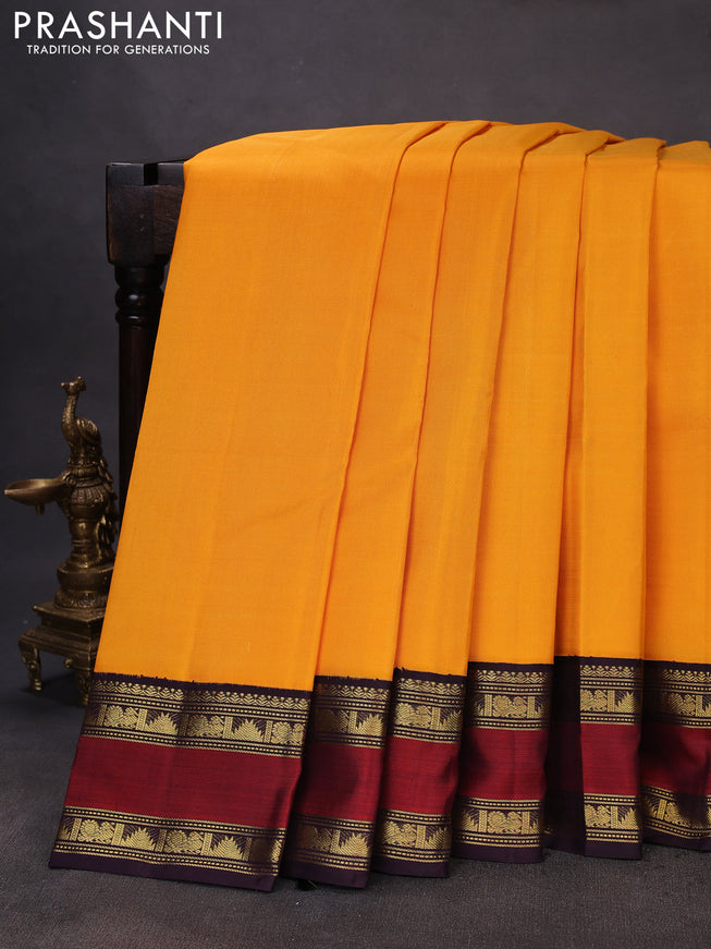 Pure kanchipuram silk saree mango yellow and deep wine with plain body and rettapet zari woven korvai border