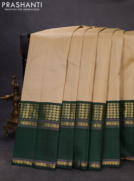 Pure kanchipuram silk saree beige and dark green with plain body and long rettapet zari woven border