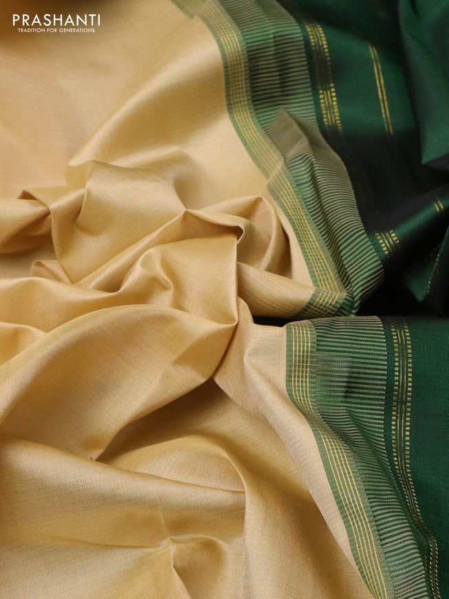 Pure kanchipuram silk saree beige and dark green with plain body and long rettapet zari woven border