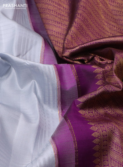 Pure kanchipuram silk saree pastel grey and purple with allover self emboss & zari buttas and long paisley zari woven korvai border