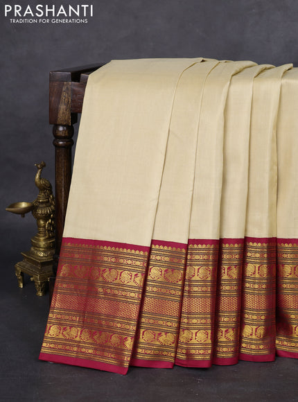 Pure kanchipuram silk saree cream and maroon with plain body and long zari woven korvai border
