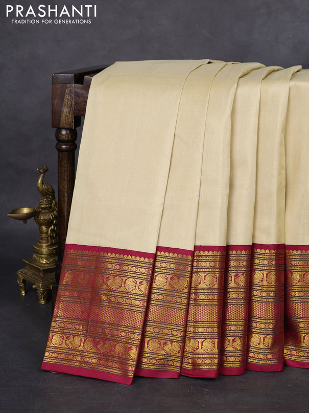 Pure kanchipuram silk saree cream and maroon with plain body and long zari woven korvai border