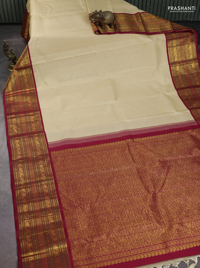 Pure kanchipuram silk saree cream and maroon with plain body and long zari woven korvai border