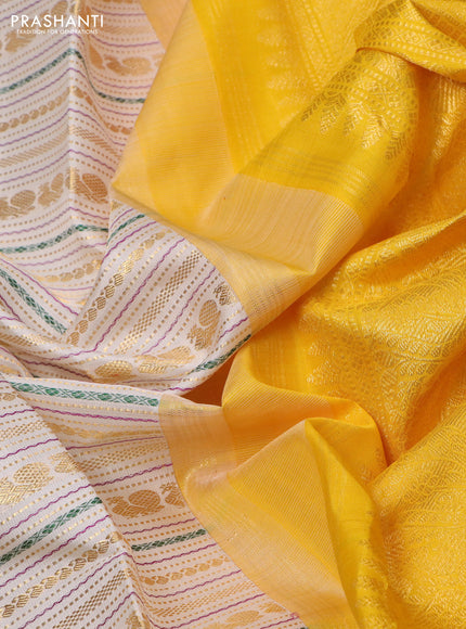 Pure kanchipuram silk saree off white and yellow with allover zari woven rocade weaves and long rettapet zari woven border