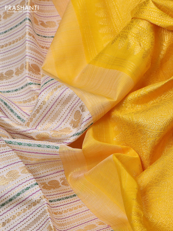 Pure kanchipuram silk saree off white and yellow with allover zari woven rocade weaves and long rettapet zari woven border