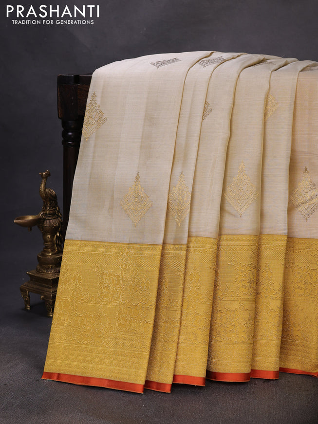 Pure kanchipuram silk saree cream and mustard yellow with zari woven buttas and long zari woven border
