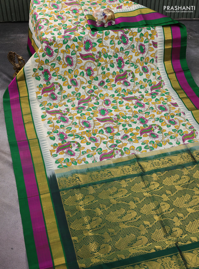 Silk cotton saree cream and green with allover kalamkari prints and temple design zari woven simple border