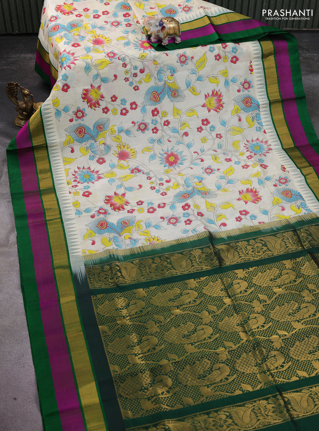 Silk cotton saree cream and green with allover kalamkari prints and temple design zari woven simple border