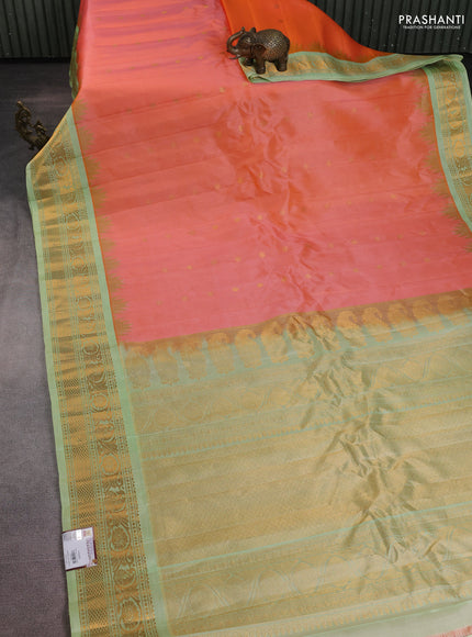 Pure gadwal silk saree dual shade of peach orange and pista green with zari woven buttas and temple design zari woven border