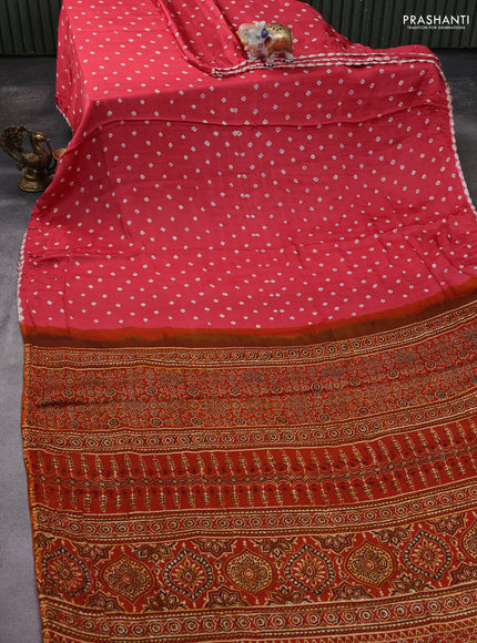 Modal silk saree peach pink and orange with allover bandhani butta prints and ajrakh printed pallu & Blouse