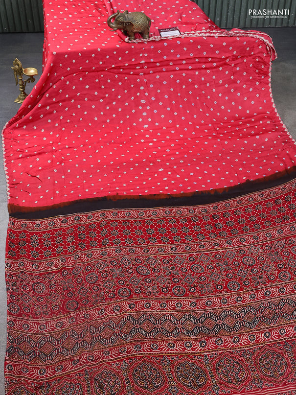 Modal silk saree peach pink and red with allover bandhani butta prints and ajrakh printed pallu & Blouse