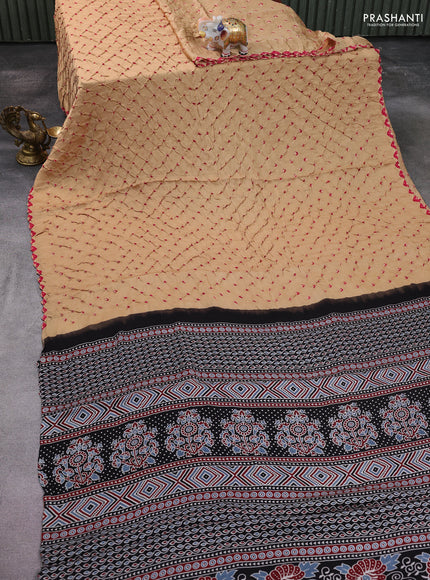 Modal silk saree sandal and black with allover bandhani butta prints and ajrakh printed pallu & Blouse