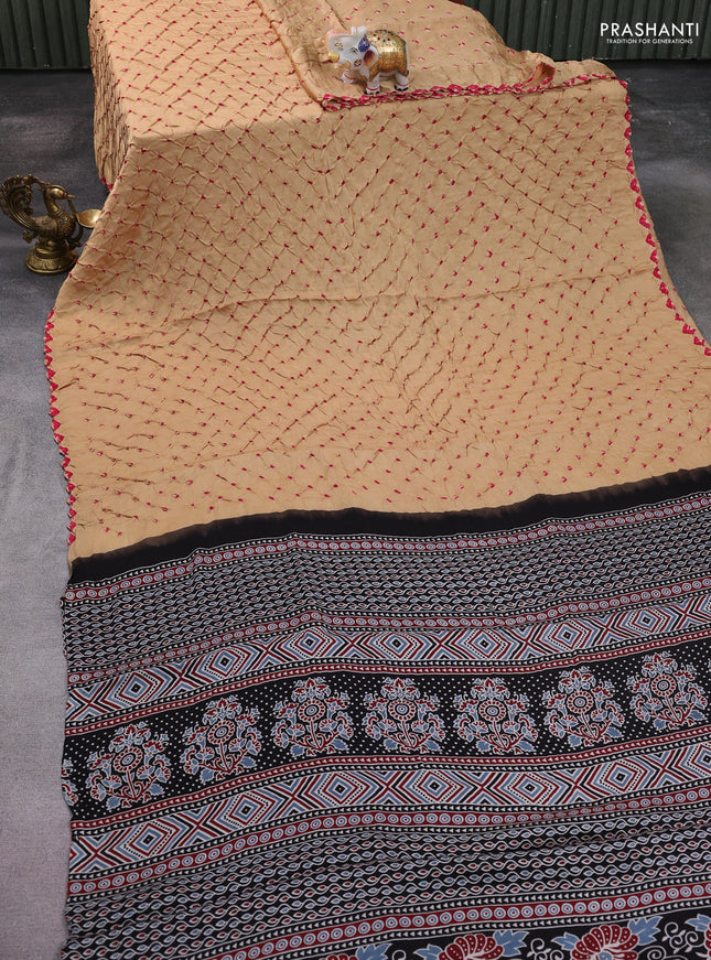 Modal silk saree sandal and black with allover bandhani butta prints and ajrakh printed pallu & Blouse