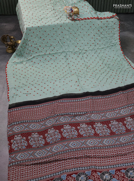 Modal silk saree pastel green and maroon with allover bandhani butta prints and ajrakh printed pallu & Blouse