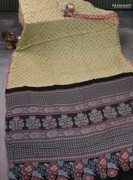 Modal silk saree pista green and black with allover bandhani butta prints and ajrakh printed pallu & Blouse